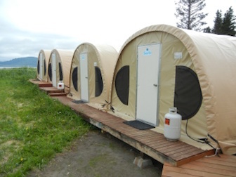 row of fabric camping tents with doors