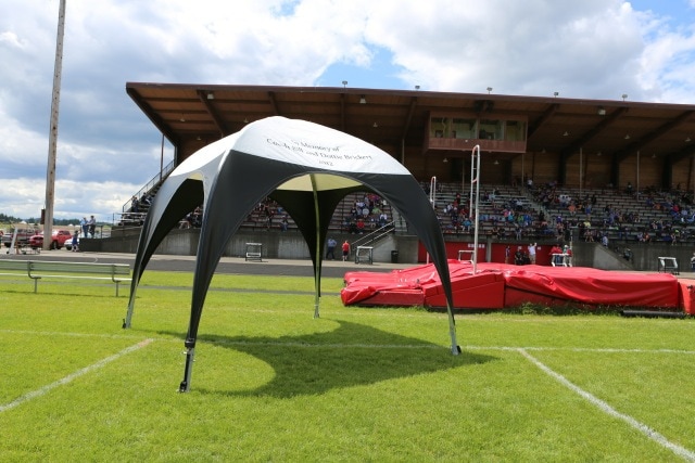 branded event canopy on football field