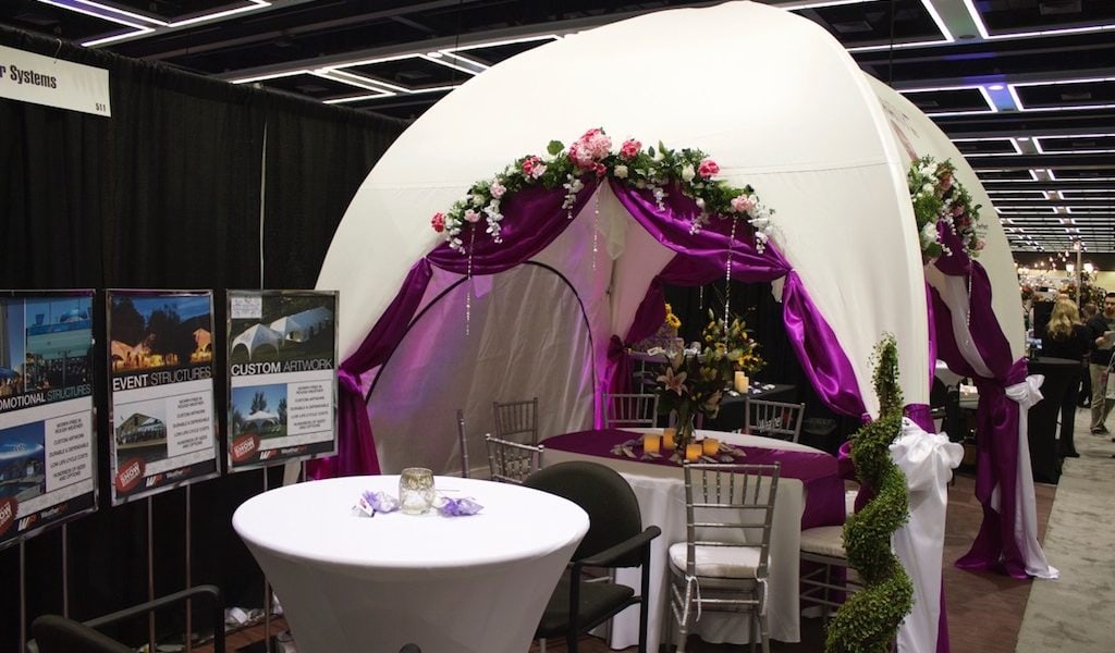 decorated wedding event tent with tables and chairs
