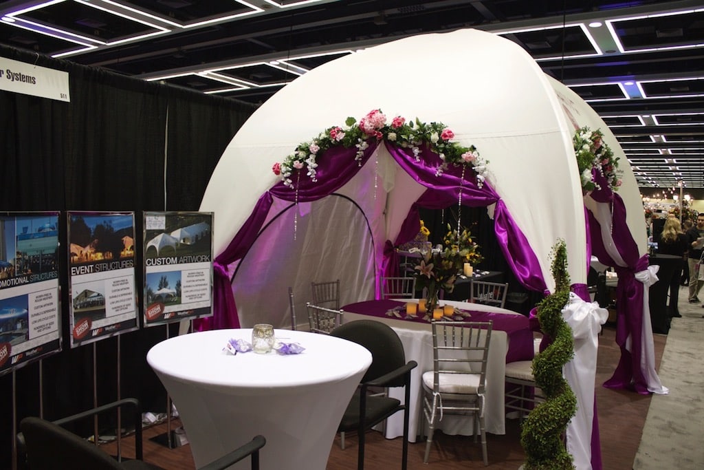 decorated wedding event tent with tables and chairs