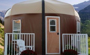brown yurt with porch front view