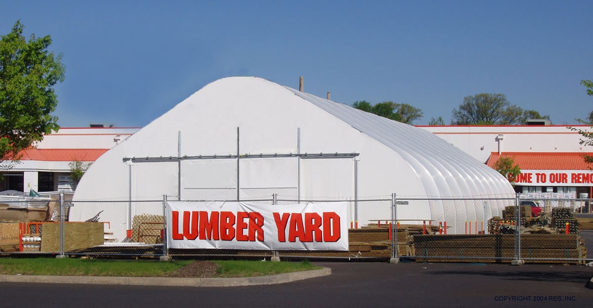 fence with 'lumber yard' sign on top of it, outside of home depot