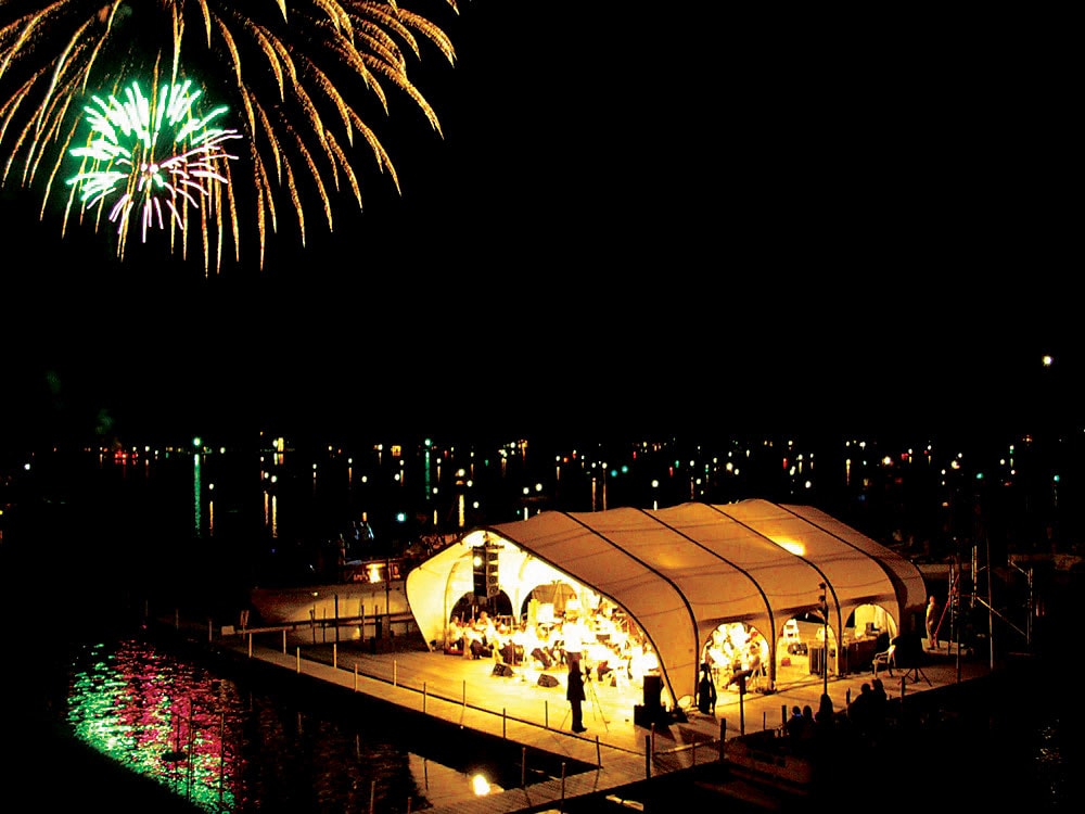 Event structure concert hall at night with fireworks in the background