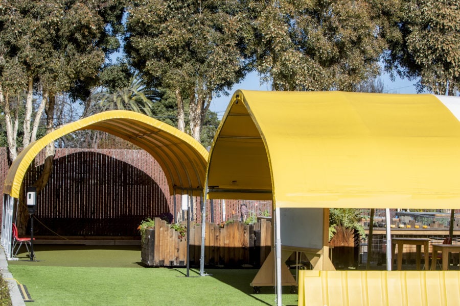 two outdoor classroom structures in the school yard