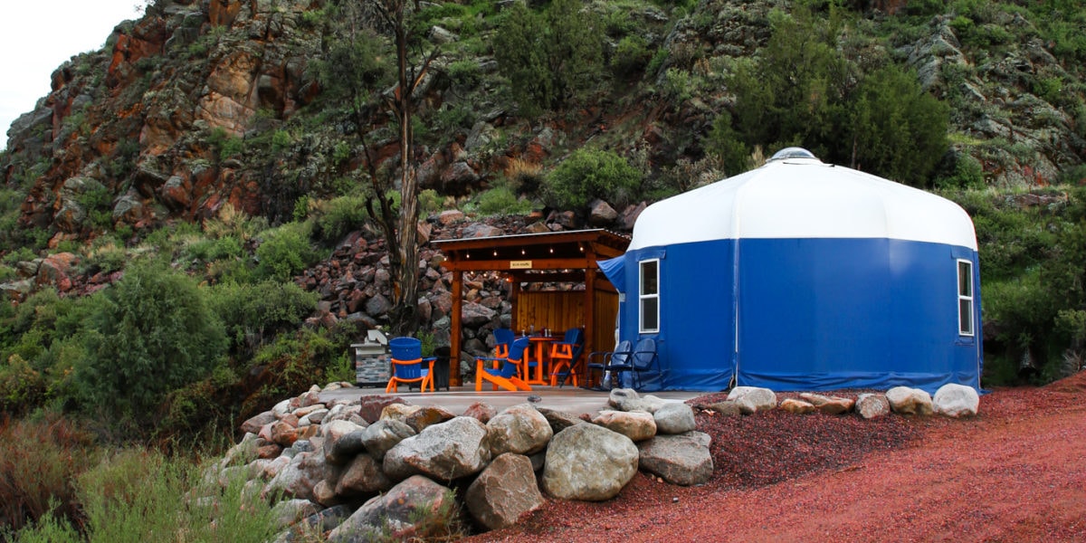 round, blue luxury yurt located in a glamping campsite